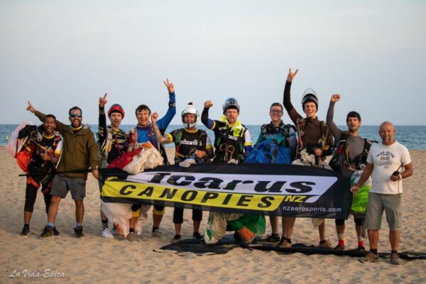 skydivers on a beach with icarus flag