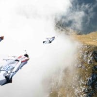Wingsuit BASE in mountains through cloud photo by Scott Patterson original photo on Icarus skydiving photography blog