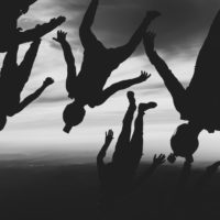 skydivers flying a tight formation during a steep angle jump