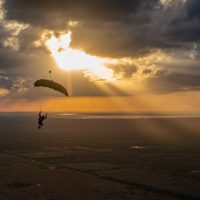skydiver flying an NZ Aerosports Icarus Leia canopy in the sunset
