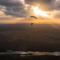 skydiver flying an NZ Aerosports Icarus Leia canopy in the sunset