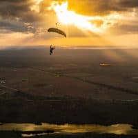skydiver flying an NZ Aerosports Icarus Leia canopy in the sunset