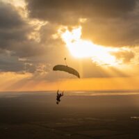 skydiver flying an NZ Aerosports Icarus Leia canopy in the sunset