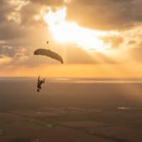 skydiver flying an NZ Aerosports Icarus Leia canopy in the sunset