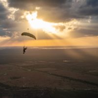 skydiver flying an NZ Aerosports Icarus Leia canopy in the sunset