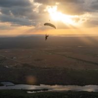 skydiver flying an NZ Aerosports Icarus Leia canopy in the sunset
