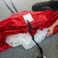 showing how to tidy slack in lines when canopy is laid on ground