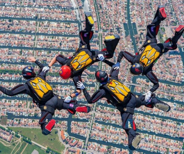 hayabusa in freefall view from above holding sidebody formation with city below