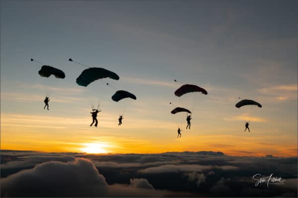 icarus canopies flocking in silhouette with sunset over cloud photo credit steve fitch
