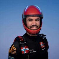 sondre tommervold wearing red cookie helmet smiling at cameraman