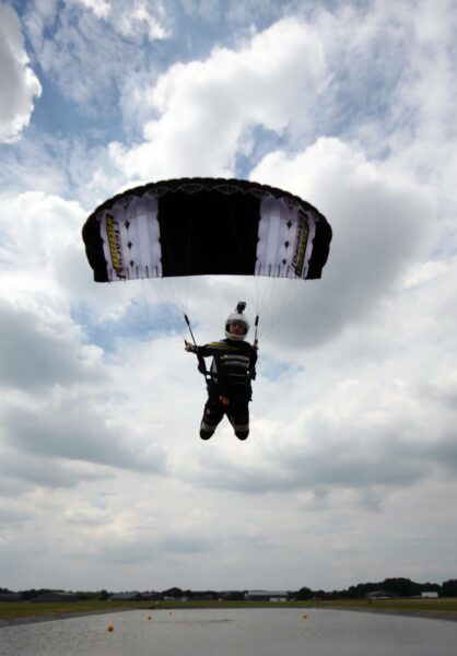 dan guest leaning forward in harness swooping petra over pond photo credit andy guest