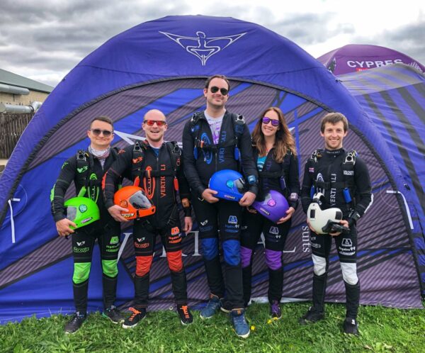 uk vfs team standing in front of tent in skydive gear holding helmets photo credit joel strickland