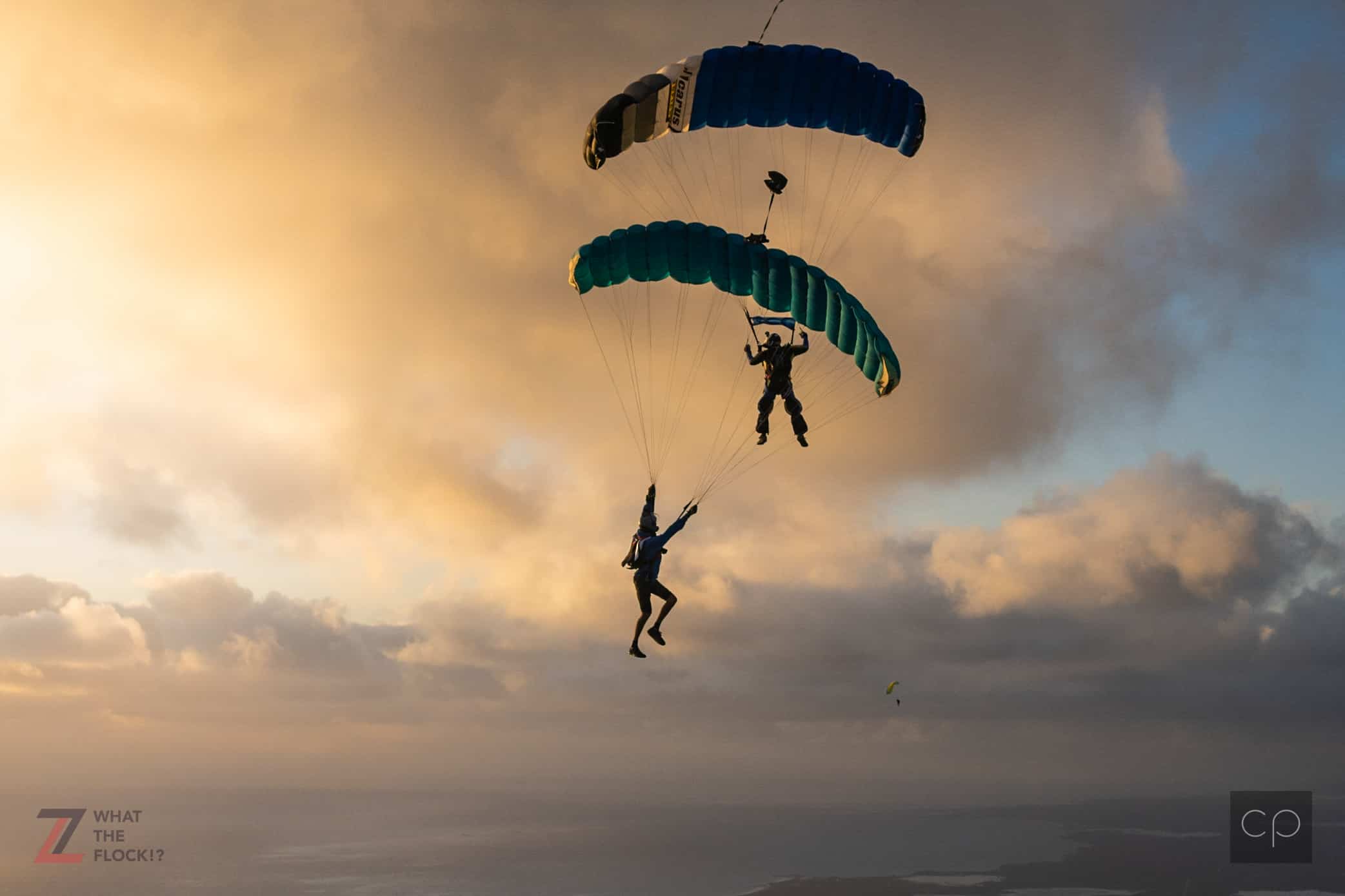 2 canopies flying towards sunset in close proximity