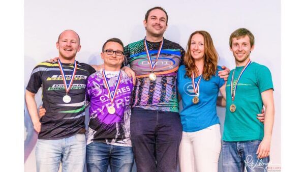 omni99 standing together arm in arm wearing medals