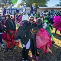 women world record project 19 skydivers hugging and smiling holding canopies on ground