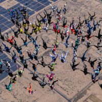women world record project 19 view from above formation skydivers holding hands flying head down with desert below