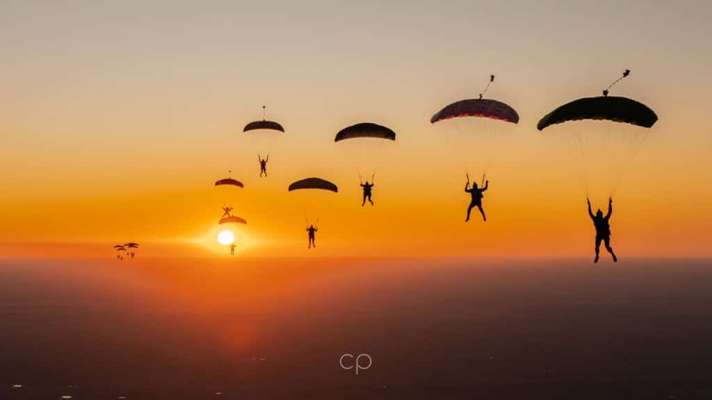 canopies flocking in formation flying towards golden sunset at jyro boogie 2023