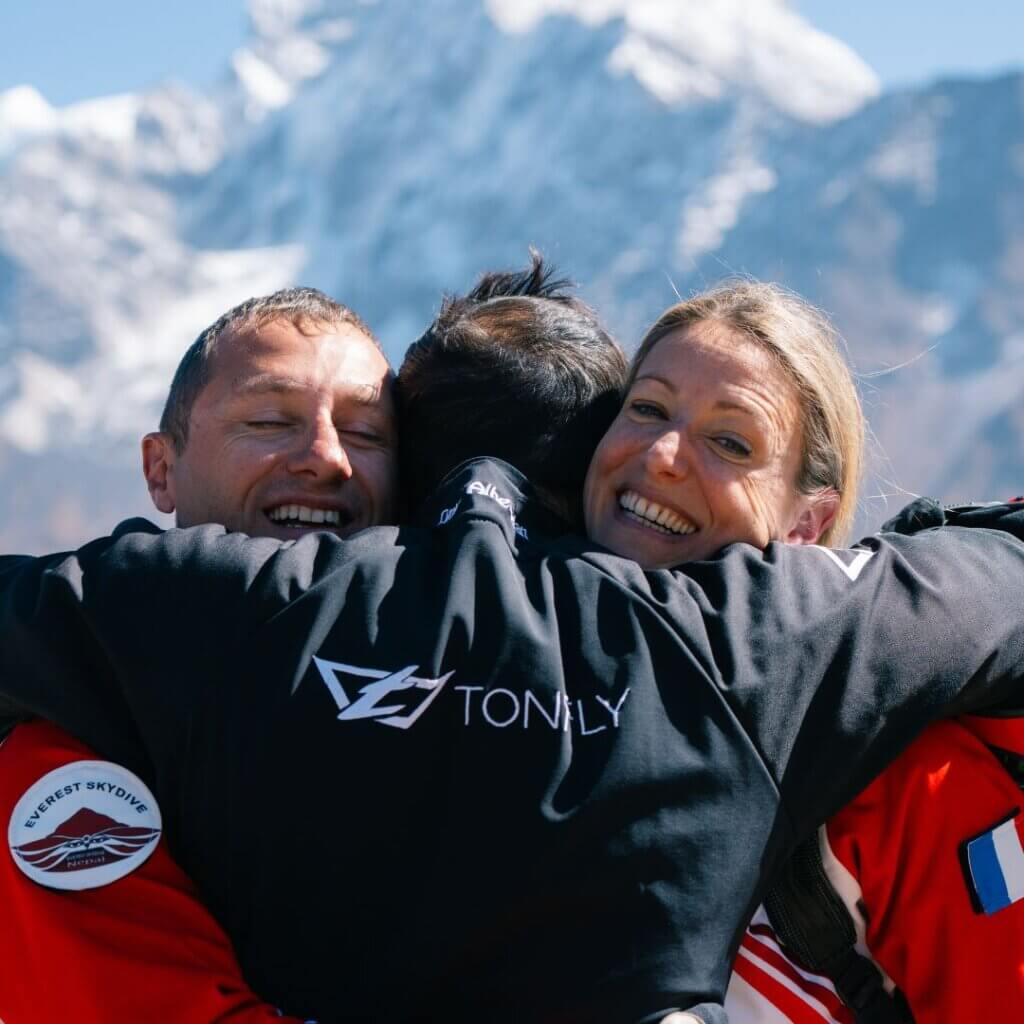 greg karine and omar hugging after completing everest skydive