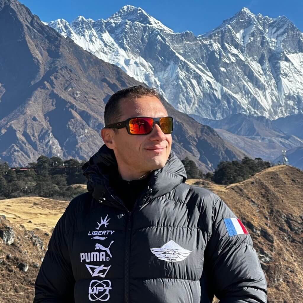 greg crozier standing in front of mount everest